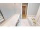 Elegant bathroom with a soaking tub, long vanity and white tiling at 3131 Nw Slaton Nw Dr # 24, Atlanta, GA 30305