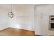 Elegant dining area with wainscoting, hardwood floors, and stylish light fixture at 3131 Nw Slaton Nw Dr # 24, Atlanta, GA 30305
