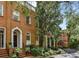 Charming brick townhome featuring lush landscaping, a private entrance, and classic architectural details at 3131 Nw Slaton Nw Dr # 24, Atlanta, GA 30305