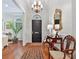 Elegant foyer boasting a striking black door, chandelier, hardwood floors, and a decorative mirror at 3131 Nw Slaton Nw Dr # 24, Atlanta, GA 30305
