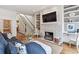 Living area featuring a fireplace, built-in shelving, and stairway to the second floor at 3131 Nw Slaton Nw Dr # 24, Atlanta, GA 30305