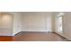 Spacious living room featuring decorative trim, hardwood floors, a closet, and a large window at 3131 Nw Slaton Nw Dr # 24, Atlanta, GA 30305