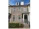 Brick townhouse featuring dark trim, and dormer windows, front door, and minimal landscaping at 3879 Glenview Club Ln, Duluth, GA 30097