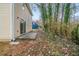 Small patio and wooded backyard with mature trees at 821 Stonebridge Park Cir, Lithonia, GA 30058