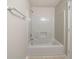 All white bathtub and shower with metal hardware at 821 Stonebridge Park Cir, Lithonia, GA 30058