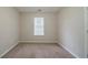 Cozy bedroom with neutral carpeting, a window and door at 821 Stonebridge Park Cir, Lithonia, GA 30058