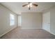 Neutral bedroom featuring plush carpeting and a ceiling fan at 821 Stonebridge Park Cir, Lithonia, GA 30058