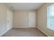 Bedroom featuring neutral walls, plush carpet, and two doors at 821 Stonebridge Park Cir, Lithonia, GA 30058