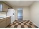 Close view of kitchen showing checkerboard floors, white countertops, and white refrigerator at 821 Stonebridge Park Cir, Lithonia, GA 30058