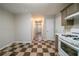 Functional kitchen with checkerboard flooring, white appliances, and convenient access to the hallway at 821 Stonebridge Park Cir, Lithonia, GA 30058