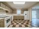Bright kitchen with updated countertops, checkerboard floors, and stainless-steel appliances at 821 Stonebridge Park Cir, Lithonia, GA 30058