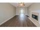 Spacious living room with hardwood floors, a fireplace, and an open view to the dining area at 821 Stonebridge Park Cir, Lithonia, GA 30058