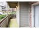 Cozy outdoor patio with wood railing, exterior light fixture, and wooded views at 2901 Lenox Ne Way # 902, Atlanta, GA 30324