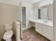 Spacious bathroom featuring a toilet, vanity with sink, and modern lighting fixture at 17 Matawan Se Cir, Smyrna, GA 30080