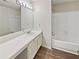 Well-lit bathroom with updated vanity, large mirror, and a shower-tub combination at 17 Matawan Se Cir, Smyrna, GA 30080