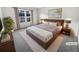 Staged bedroom with a large window, neutral paint, and plush carpeting at 17 Matawan Se Cir, Smyrna, GA 30080