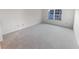 Bright bedroom with a large window and plush neutral carpeting at 17 Matawan Se Cir, Smyrna, GA 30080