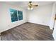 Bright bedroom featuring wood laminate flooring and a large sun-drenched window at 17 Matawan Se Cir, Smyrna, GA 30080