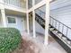Exterior view showcasing staircase with black metal railings, white posts, and neatly trimmed bushes at 17 Matawan Se Cir, Smyrna, GA 30080