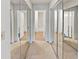 Hallway with carpeted floor and mirrored closet doors, leading to additional rooms at 17 Matawan Se Cir, Smyrna, GA 30080