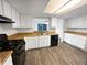 Well-lit kitchen with black appliances, wood countertops and durable hardwood floors at 17 Matawan Se Cir, Smyrna, GA 30080