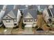 A two-story home with a dark roof and red shutters on a small lot with an attached garage at 5223 Catrina Way, Buford, GA 30519