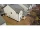 A view of the back of a two-story home, showing the yard, patio, and dark roof at 5223 Catrina Way, Buford, GA 30519