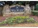 Stone sign announces the Willow Leaf community, framed by colorful flower bed at 5223 Catrina Way, Buford, GA 30519