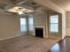 Bright living room featuring a fireplace, large windows, and a decorative trey ceiling at 5223 Catrina Way, Buford, GA 30519