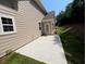Side view of backyard with concrete patio and siding at 117 Legends Way, Hiram, GA 30141