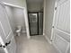 Bathroom featuring glass shower, gray tile floor, and modern fixtures at 117 Legends Way, Hiram, GA 30141