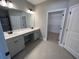 Bathroom featuring double sink vanity, tile floors, and large mirror at 117 Legends Way, Hiram, GA 30141