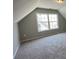 Neutral carpeted bedroom featuring a large window for natural light at 117 Legends Way, Hiram, GA 30141