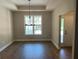 Inviting dining room featuring dark hardwood floors and a stylish chandelier at 117 Legends Way, Hiram, GA 30141
