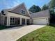 Charming one-story home featuring stone accents, a spacious driveway, and a convenient two-car garage at 117 Legends Way, Hiram, GA 30141