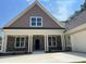 Inviting one-story home showcasing stone accents, a covered porch, and a convenient two-car garage at 117 Legends Way, Hiram, GA 30141