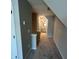 Carpeted hallway on second floor, leads to a bathroom with gray vanity at 117 Legends Way, Hiram, GA 30141