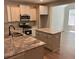 Well-lit kitchen boasts stainless steel appliances, granite countertops, and a convenient center island at 117 Legends Way, Hiram, GA 30141