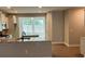 Bright kitchen showcasing stainless steel appliances, granite countertops, and an open layout to the living area at 117 Legends Way, Hiram, GA 30141