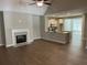 Inviting living area featuring a cozy fireplace, vaulted ceiling, and an open layout to the kitchen at 117 Legends Way, Hiram, GA 30141