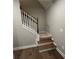 Staircase with wood and carpeted steps and white railings at 117 Legends Way, Hiram, GA 30141