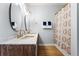 Stylish bathroom with a double sink vanity with marble countertop and a patterned shower curtain at 2832 Old Villa Rica Rd, Powder Springs, GA 30127