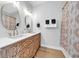 Chic bathroom featuring a dual sink vanity with designer details and marble countertops at 2832 Old Villa Rica Rd, Powder Springs, GA 30127