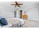 Carpeted bedroom featuring a ceiling fan, closet, and natural light at 2832 Old Villa Rica Rd, Powder Springs, GA 30127