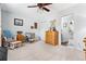 Light-filled room featuring neutral carpet, chair with ottoman, and a natural wood dresser at 2832 Old Villa Rica Rd, Powder Springs, GA 30127