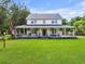 Charming two-story home with a sprawling porch, lush lawn, and an American flag waving proudly at 2832 Old Villa Rica Rd, Powder Springs, GA 30127