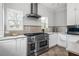 Kitchen featuring stainless steel oven and range with a vent hood, granite countertops, and white cabinets at 2832 Old Villa Rica Rd, Powder Springs, GA 30127
