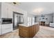 Open kitchen featuring a stainless steel refrigerator and a center island that opens to a living and dining area at 2832 Old Villa Rica Rd, Powder Springs, GA 30127
