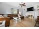 Cozy living room with a leather sofa, fireplace, and decorative windows that brings in natural light at 2832 Old Villa Rica Rd, Powder Springs, GA 30127