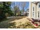 Large backyard featuring a patio area, lush lawn, garden beds, and mature trees at 2952 Nestle Creek Dr, Marietta, GA 30062